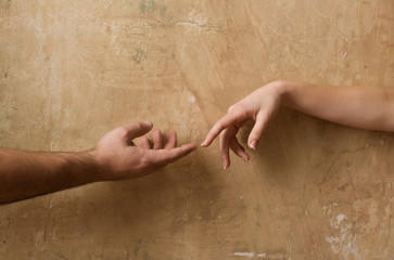 Male and female hands reaching to each other