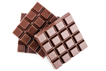Three pieces of bitter, dark chocolate bar, isolated on white background, close-up, top view