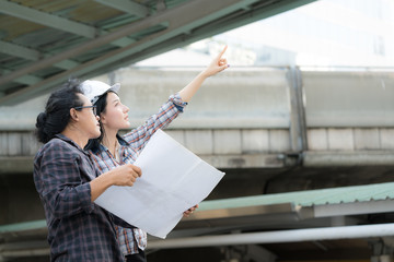 Asian Engineer Woman and Architect on activity in Site construction project