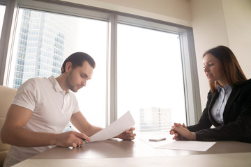 Female company director explaining to new employee terms of working contract, assignment to a position. Manager offering customer to sign papers, male client clarifying details of a deal