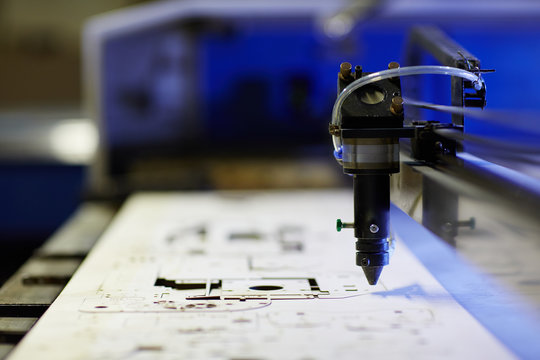 Laser machine drilling shapes from plywood