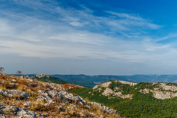The mountain view with the nice blue sky and little light clouds in the warm sun light if afternoon in Crimea, Ukraine