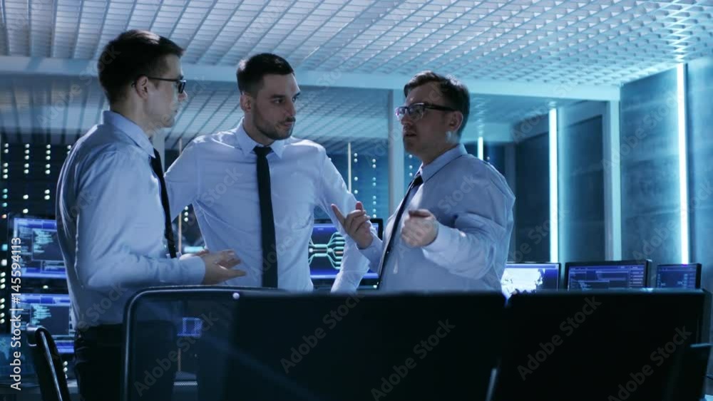 Aufkleber three technical moderators have active discussion in monitoring room. system control room is full of