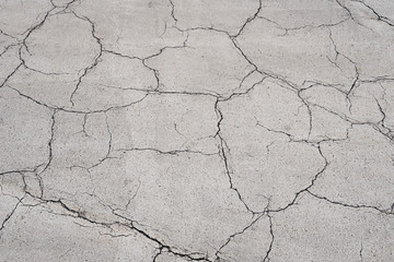 Texture of the old asphalt crosswalk cracked.