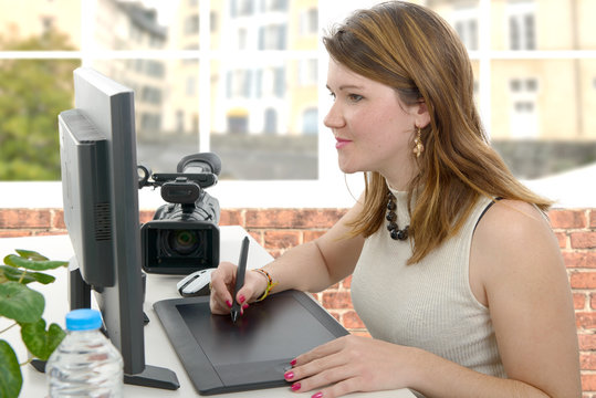young woman designer using graphics tablet