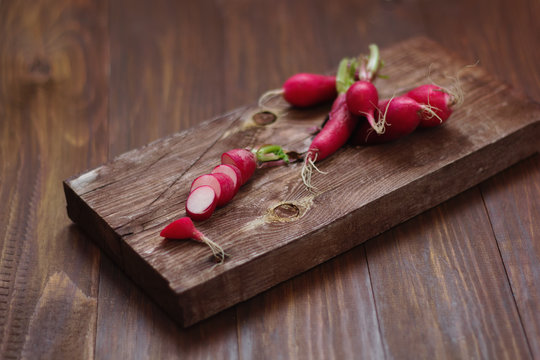 radishes on a wooden cutting Board on a rustic wooden table. selective focus.