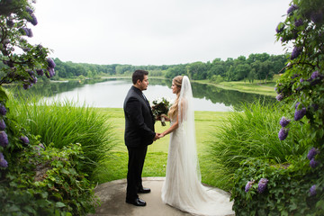 Bride and bridegroom holding hands and staring into each others eyes