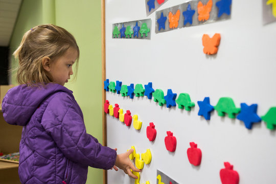 Young girl at whiteboard in classroom