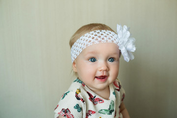 Portrait of a beautiful little girl of European appearance in a dress