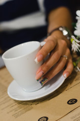 Only one hand woman holding a cup of coffe