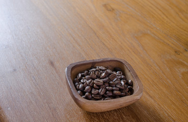 roasted coffee beans in wooden bow