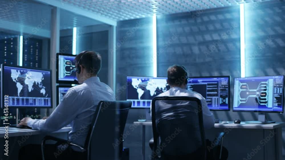 Aufkleber panorama shot of system control room with three technical controllers working at their workstations 