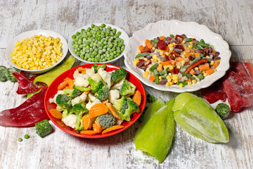 Frozen vegetables in plate and bowl, frozen vegetables retain all the nutrients - healthy eating - obrazy, fototapety, plakaty