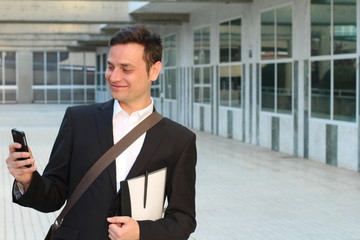 Businessman celebrating his success on smartphone - Stock image with copy space