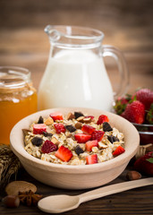 Oatmeal porridge with honey, strawberries and nuts