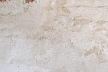 Vintage brick wall with  shabby white stucco, detailed  texture.