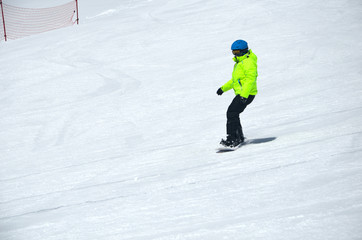 Fototapeta na wymiar People snowboarding on snow of beautiful slopes of the Caucasus Mountains