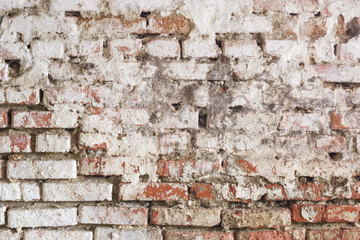 Grungy brick wall with  shabby white stucco. Vintage background.