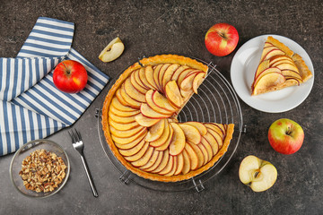 Metal stand with homemade apple pie on table