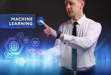 Business, Technology, Internet and network concept. Young businessman working on a virtual screen of the future and sees the inscription: Machine learning