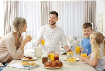 Obraz na płótnie Canvas Happy family having breakfast on kitchen