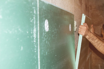 Builder insulates the walls inside the building. construction work