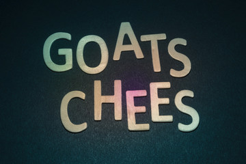 Goats Chees written with colorful wooden letters on a blue background