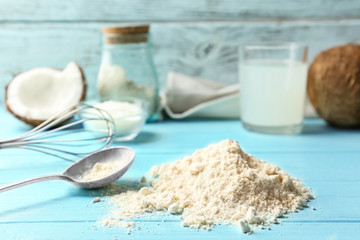 Heap of coconut flour on wooden background