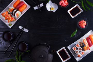 Japanese sushi dish frame on black wooden background with copy space - Powered by Adobe