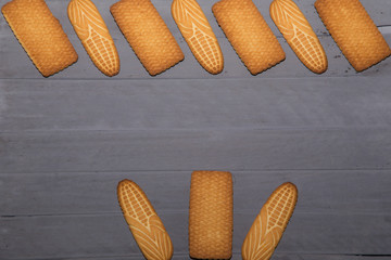 Cookies background. Sweet chips biscuits at wood background with copy space. Fattening dessert for tea on wooden table top view