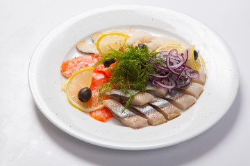 Sliced fish assortment with caviar and lemon