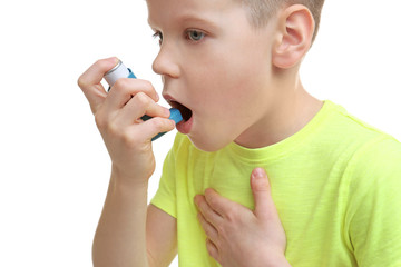 Little boy using asthma inhaler, closeup