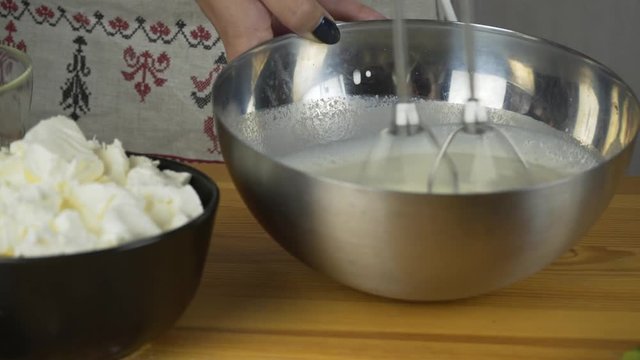 Whisking egg whites and adding sugar. Making pastry dough. Making torte with buttercream filling and grated chocolate topping. Series.