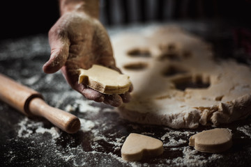 Cook makes dough pastry in baking molds
