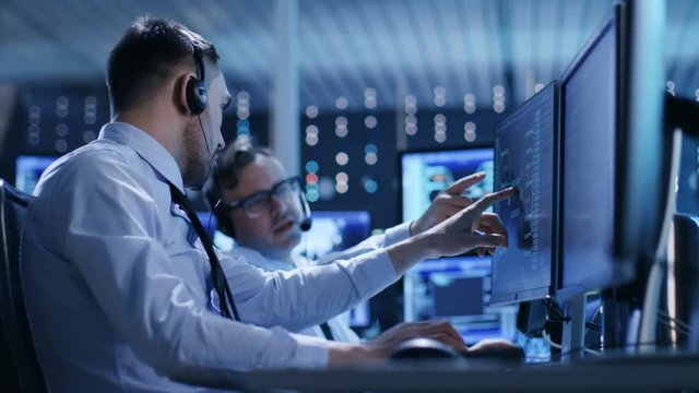 In the System Control Center Technical Support Team Gives Instructions with the Help of the Headsets. Possible Air Traffic/ Power Plant/ Security Room Theme.