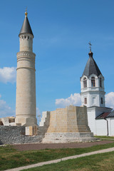 Fototapeta premium Minaret of Cathedral mosque and belltower of Church of Assumption. Bulgar, Russia
