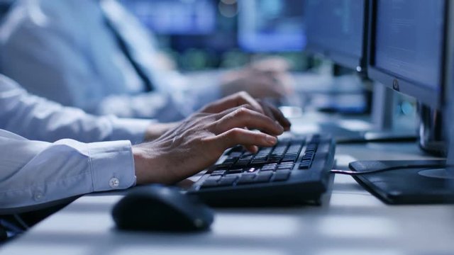 In the System Control Center Team of Technicians Monitor System Stability. Hands Close-up Shot. Possible Air Traffic/ Power Plant/ Security Room Theme. Shot on RED EPIC-W 8K Helium Cinema Camera.