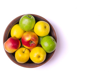 The concept of healthy eating, fresh apples in a plate, isolated on white.