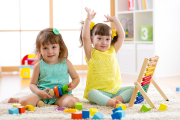 Little kids play with abacus and constructor toys, early learning