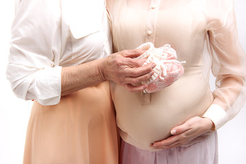 Mature female person hugging her younger one