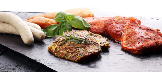 Selection of marinaded meat for grilling and sausages