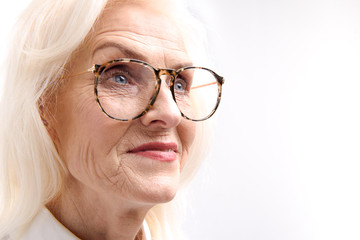 Interested mature woman glancing aside