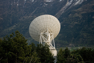 Landscape: white radio telescope during sunset on the Swiss mountains, on a spring day, Alps, Switzerland
