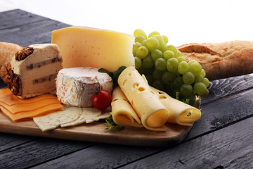 Cheese platter with different cheese and grapes
