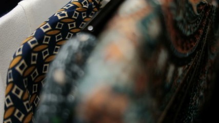 Shooting clothes woman hangers constantly in store indoors. Close up Shot clothing in score, long line with black rack with dresses, skirts, coats, sweaters, jackets, pants, blouses of different - Powered by Adobe