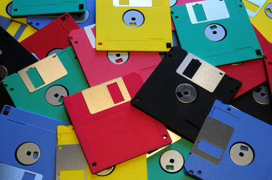 Multicolored floppy disc 3.5 for old computers. Aligned as background.