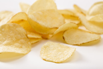 Fototapeta na wymiar Crispy potato chips isolated on white background close-up