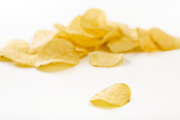 Crispy potato chips isolated on white background  close-up