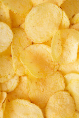 Crispy potato chips background. top view 