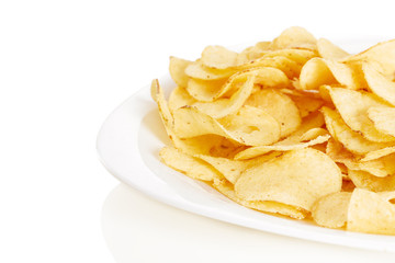 Crispy potato chips in plate on white background close-up